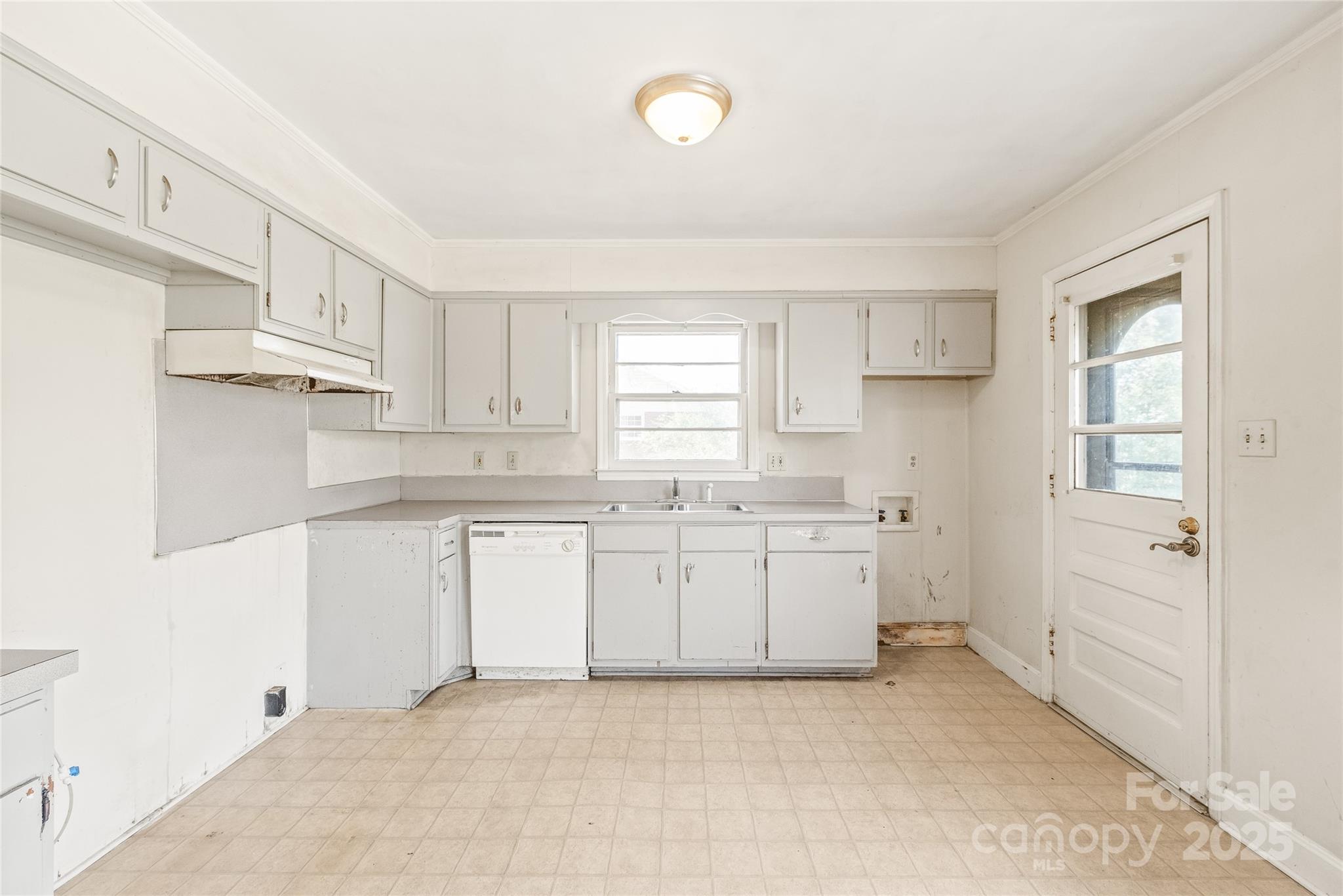 7207 Idlewild Road Charlotte, NC 28212 - Photo 6 of 15 a kitchen with granite countertop white cabinets and white appliances