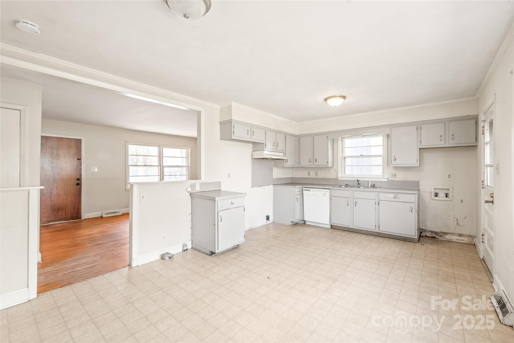 7207 Idlewild Road Charlotte, NC 28212 - Photo 7 of 15 a kitchen with white cabinets and window