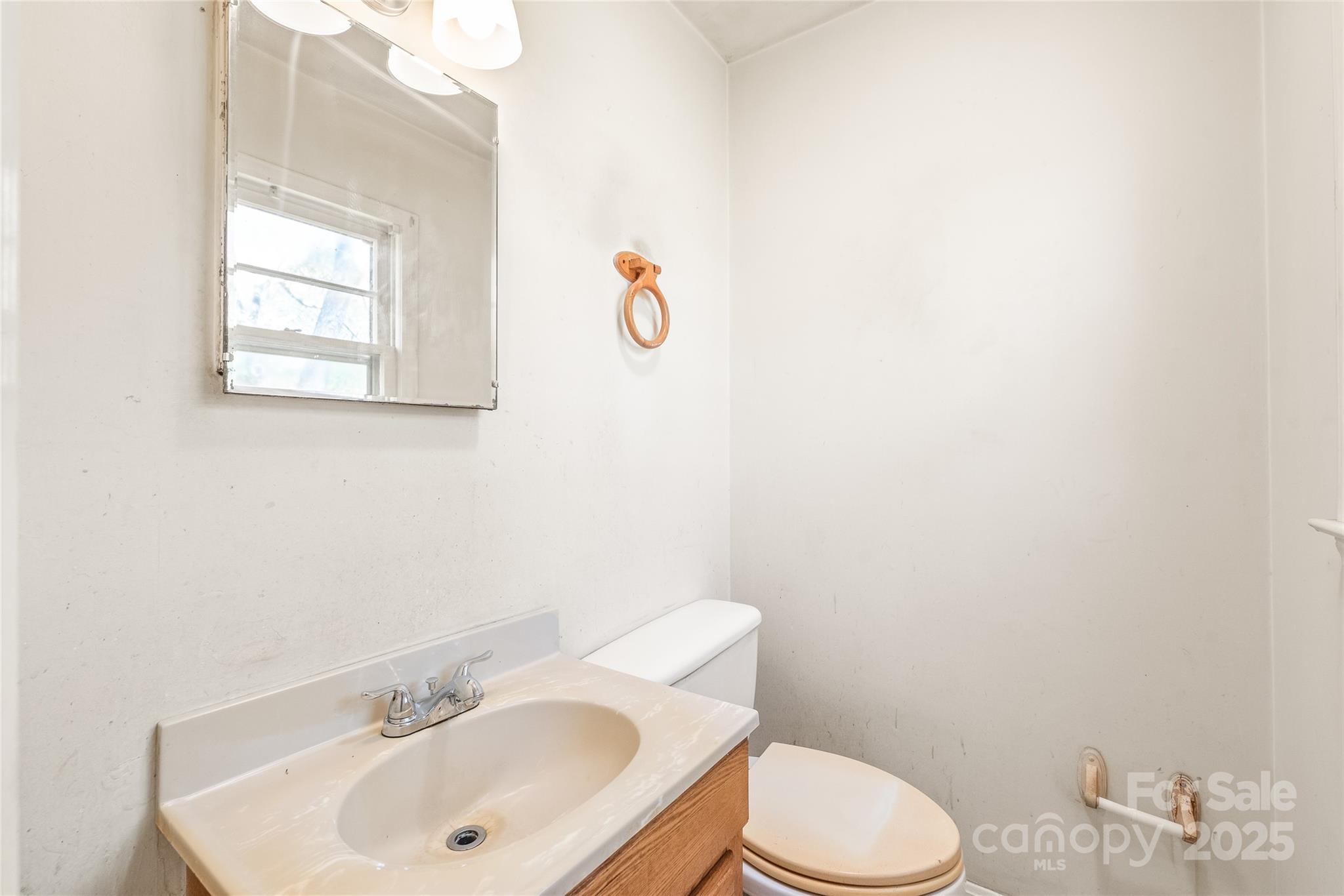 7207 Idlewild Road Charlotte, NC 28212 - Photo 9 of 15 a bathroom with a sink mirror vanity and a toilet