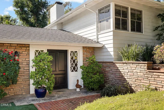 a view of a hallway with wooden floor and front door