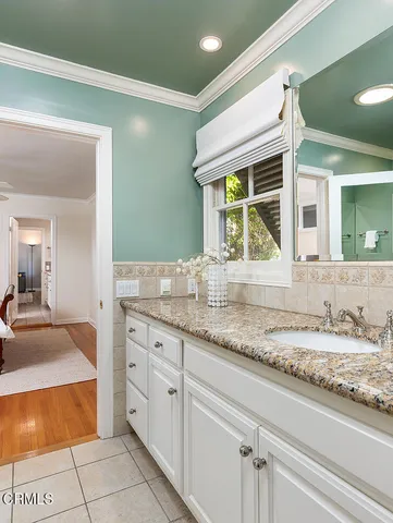 a bathroom with a sink a toilet and shower curtain