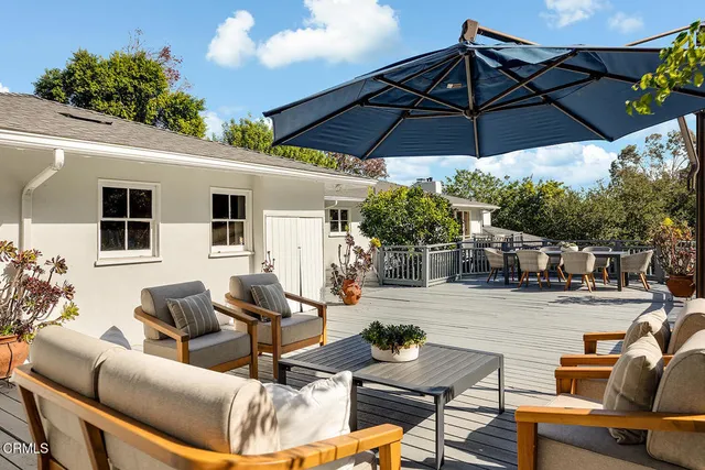 a view of a balcony with two chairs and a fire pit
