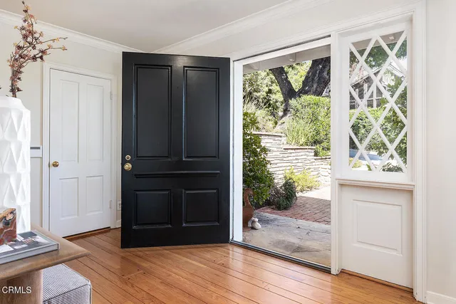 a living room with fireplace furniture and a floor to ceiling window