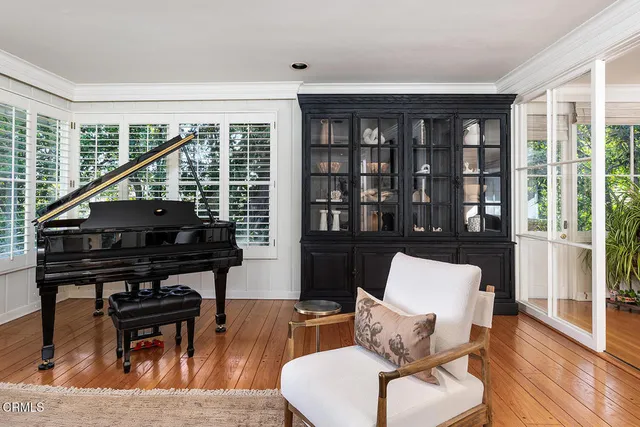 a living room with furniture and large windows