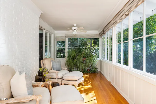 a living room with furniture and large windows