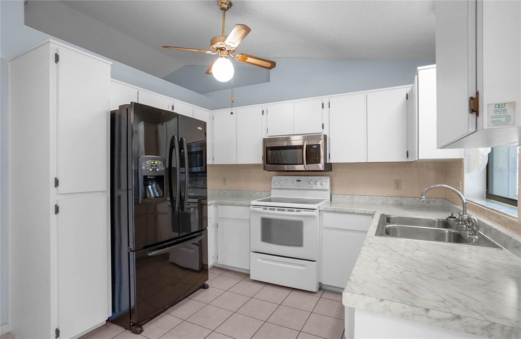3341 South Jean Point Inverness, FL 34450 - Photo 11 of 39 a kitchen with stainless steel appliances a stove microwave and a refrigerator