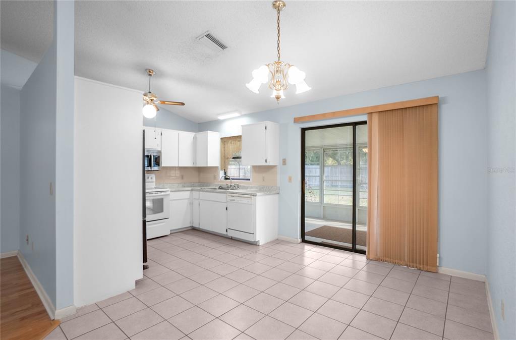 3341 South Jean Point Inverness, FL 34450 - Photo 8 of 39 a large white kitchen with a window and stainless steel appliances