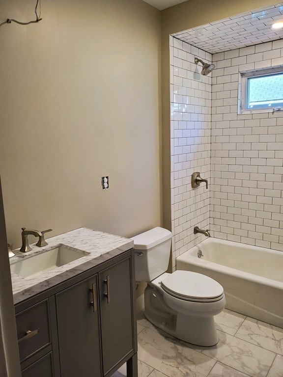 22 Allen Street, Unit 2 Arlington, MA 02474 - Photo 17 of 25 a bathroom with a sink a toilet and shower