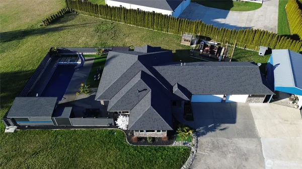 an aerial view of a house with a yard and sitting area