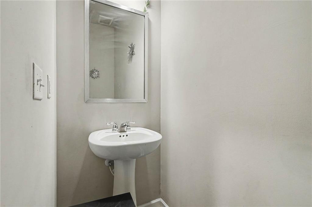 6182 Redan Overlook, Unit 97 Lithonia, GA 30058 - Photo 14 of 23 a bathroom with a sink and a mirror