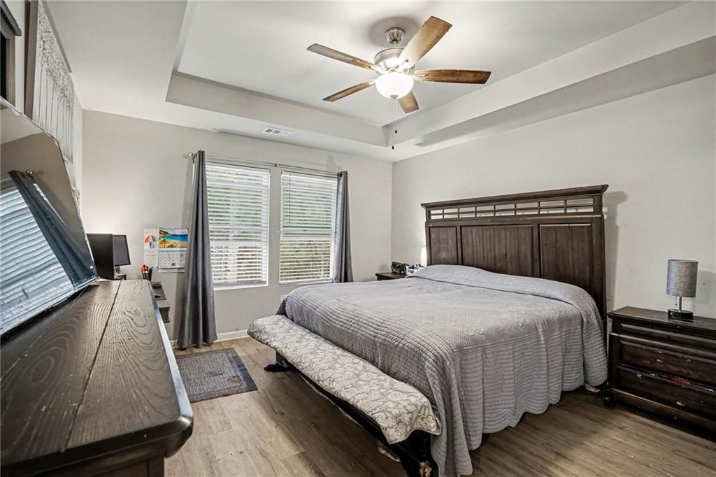 6182 Redan Overlook, Unit 97 Lithonia, GA 30058 - Photo 16 of 23 a bedroom with a large bed and a large window