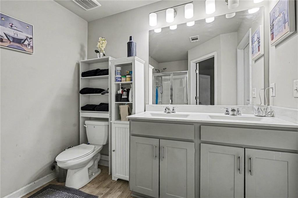 6182 Redan Overlook, Unit 97 Lithonia, GA 30058 - Photo 17 of 23 a bathroom with a toilet sink and mirror