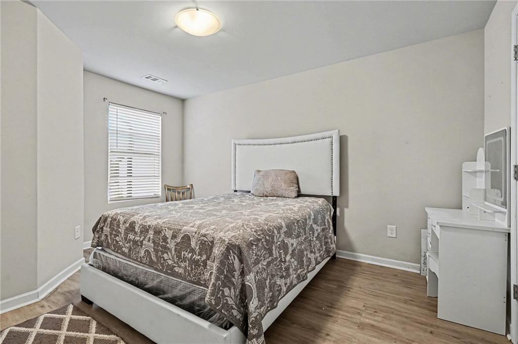 6182 Redan Overlook, Unit 97 Lithonia, GA 30058 - Photo 19 of 23 a bedroom with a bed and a window