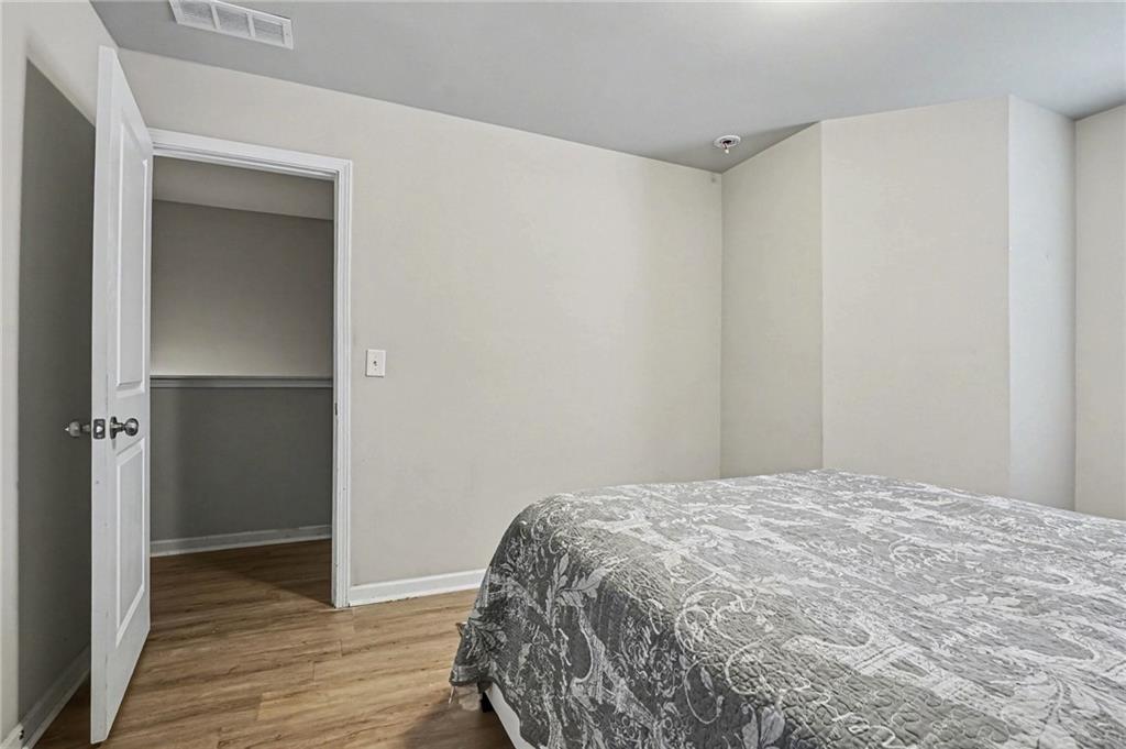 6182 Redan Overlook, Unit 97 Lithonia, GA 30058 - Photo 20 of 23 a bedroom with a bed and wooden floor