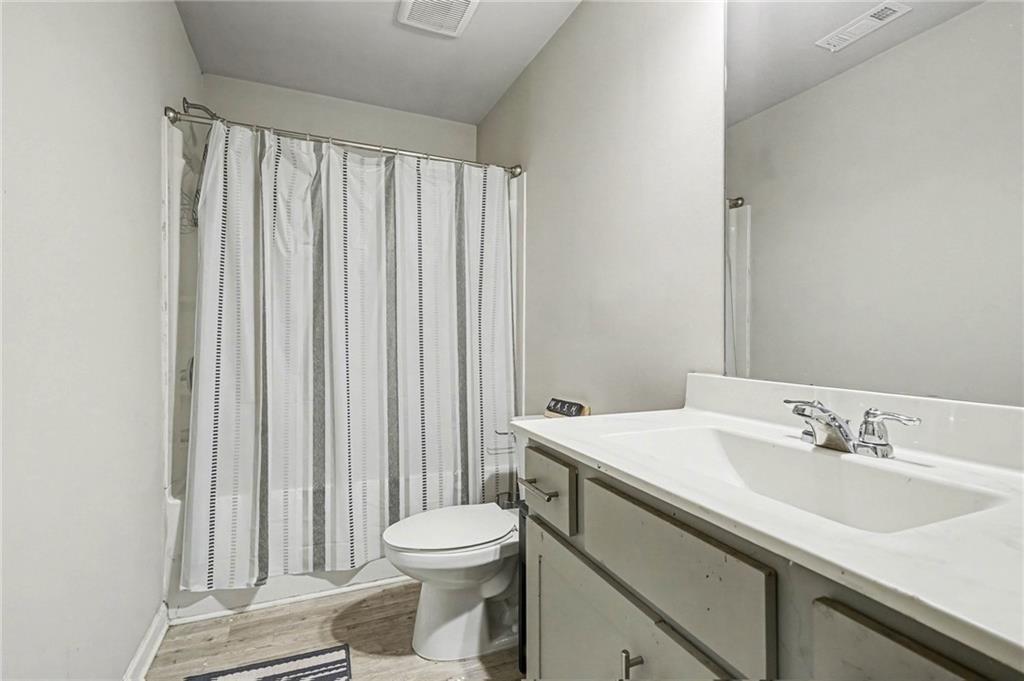 6182 Redan Overlook, Unit 97 Lithonia, GA 30058 - Photo 22 of 23 a bathroom with a sink a toilet and a mirror