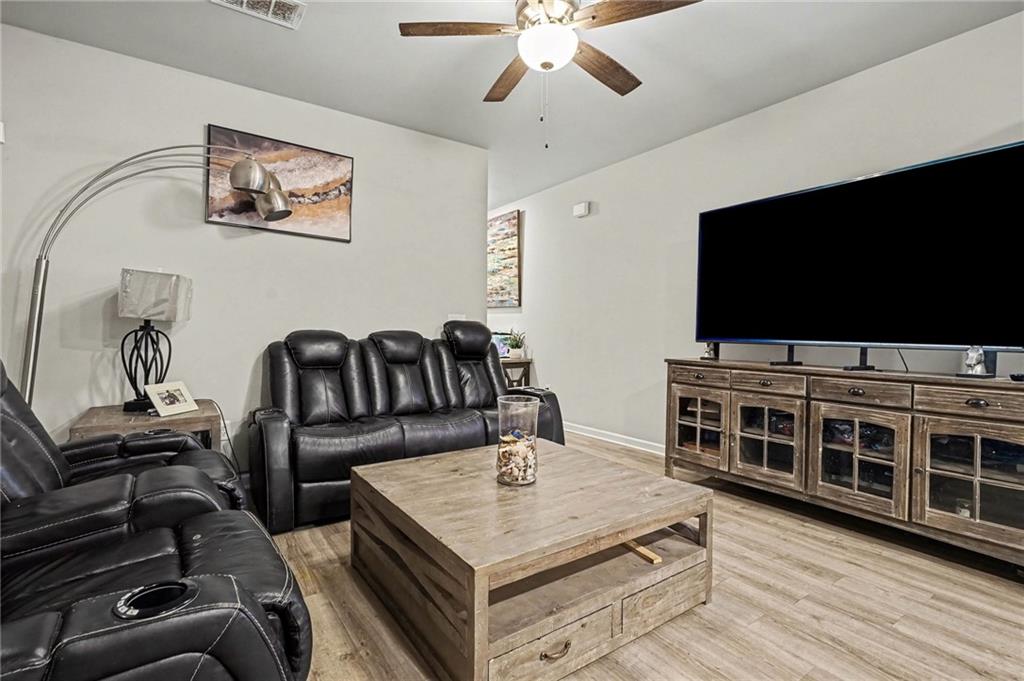 6182 Redan Overlook, Unit 97 Lithonia, GA 30058 - Photo 4 of 23 a living room with furniture and a flat screen tv