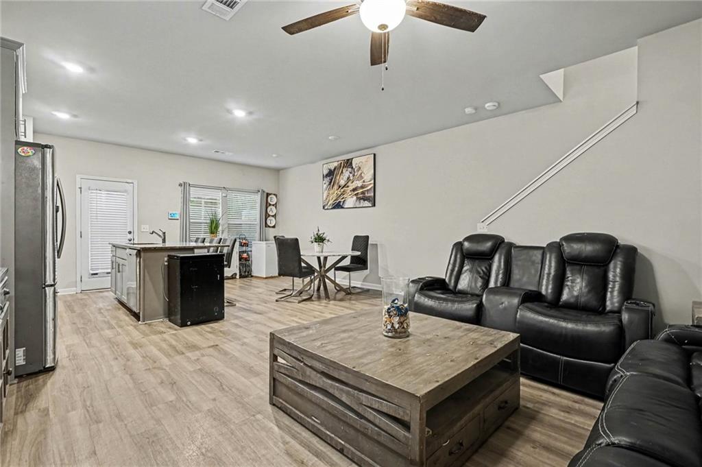 6182 Redan Overlook, Unit 97 Lithonia, GA 30058 - Photo 5 of 23 a living room with furniture a flat screen tv and kitchen view