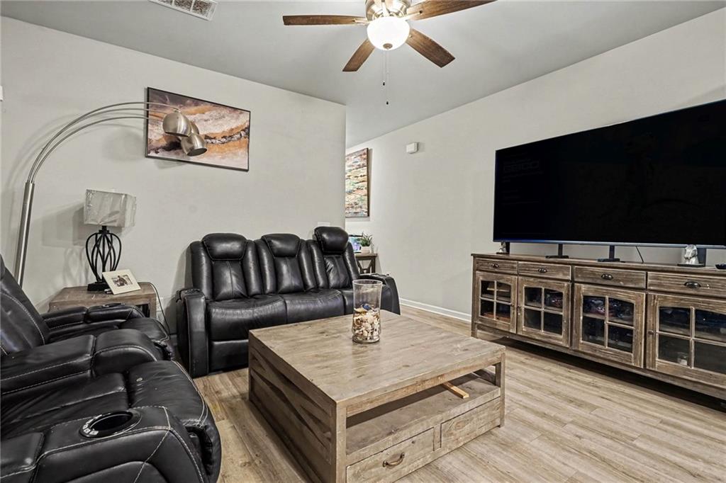 6182 Redan Overlook, Unit 97 Lithonia, GA 30058 - Photo 6 of 23 a living room with furniture and a flat screen tv