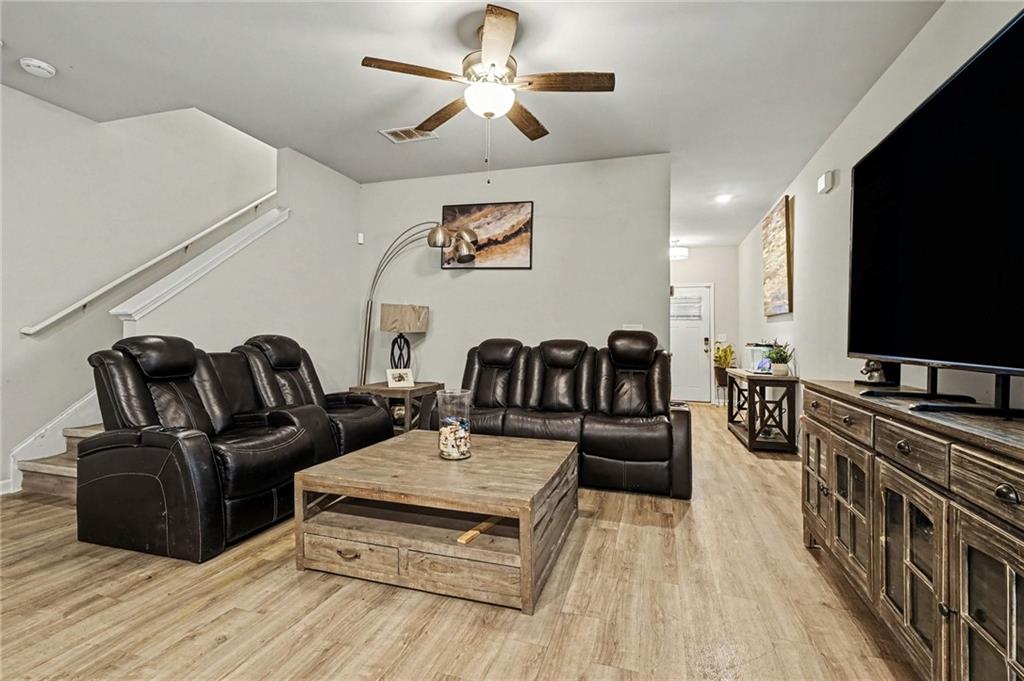 6182 Redan Overlook, Unit 97 Lithonia, GA 30058 - Photo 7 of 23 a living room with furniture and a flat screen tv
