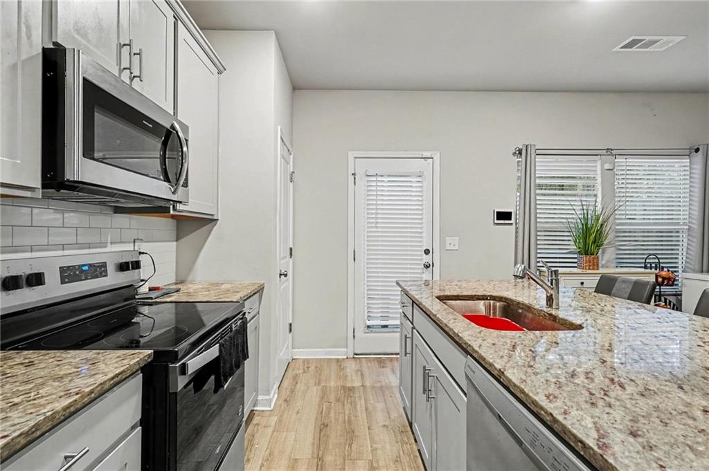 6182 Redan Overlook, Unit 97 Lithonia, GA 30058 - Photo 10 of 23 a kitchen with a stove microwave and sink