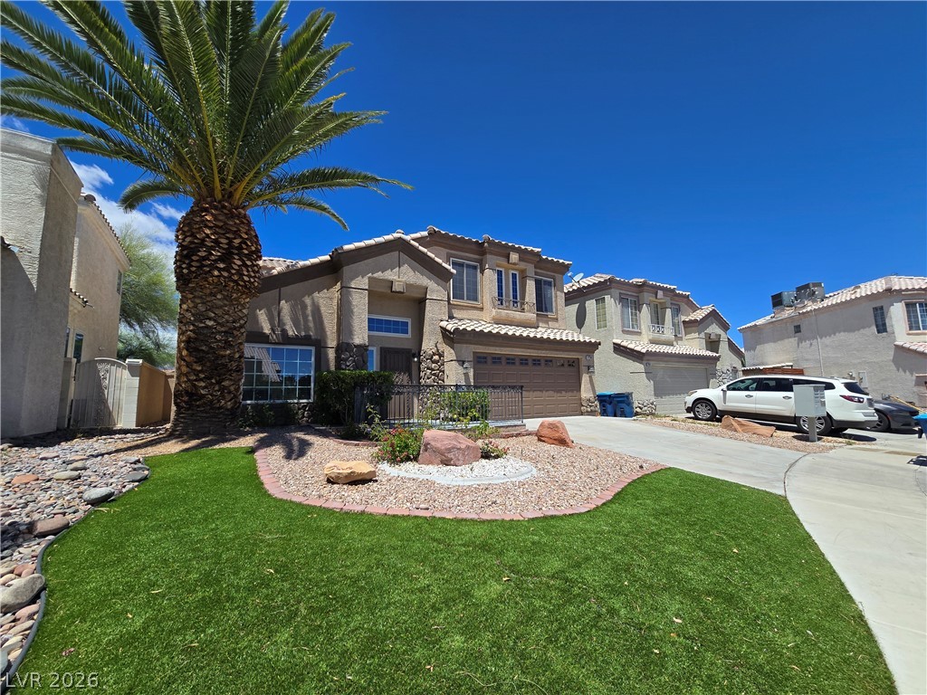3759 Funston Way Las Vegas, NV 89129 - Photo 16 of 31 A desert-friendly landscape with artificial turf and a prominent palm tree welcomes residents home.