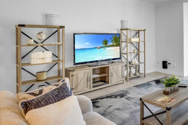 a dining room with furniture and a floor to ceiling window