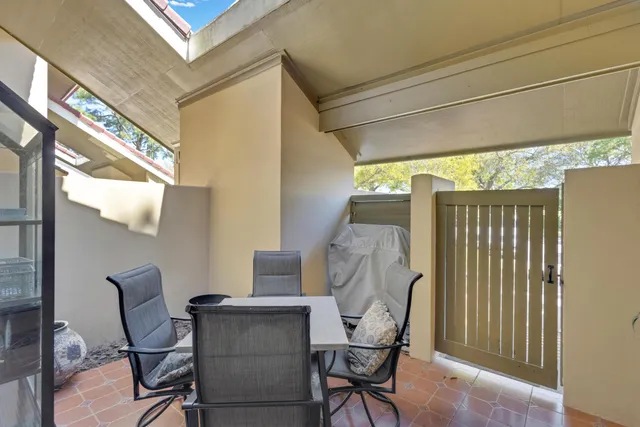 a view of a chairs and table in the balcony