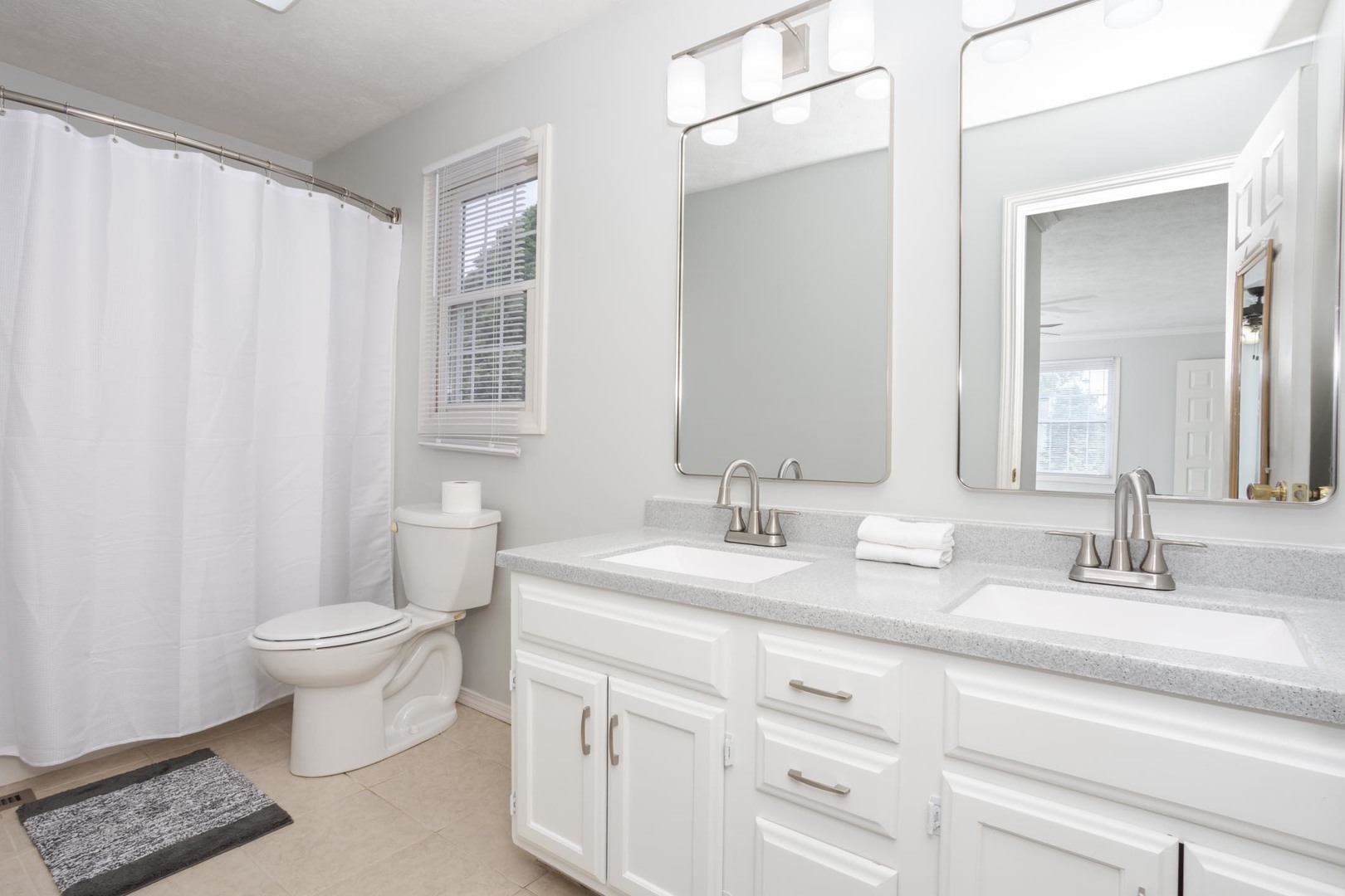 814 Landau Lane Normal, IL 61761 - Photo 37 of 58 a bathroom with a granite countertop sink a toilet and a mirror