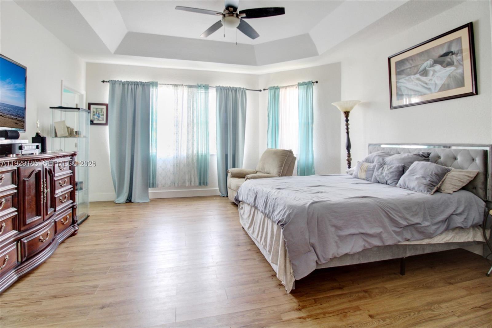 1156 Northeast 37th Place Homestead, FL 33033 - Photo 14 of 35 a spacious bedroom with a bed and a flat screen tv