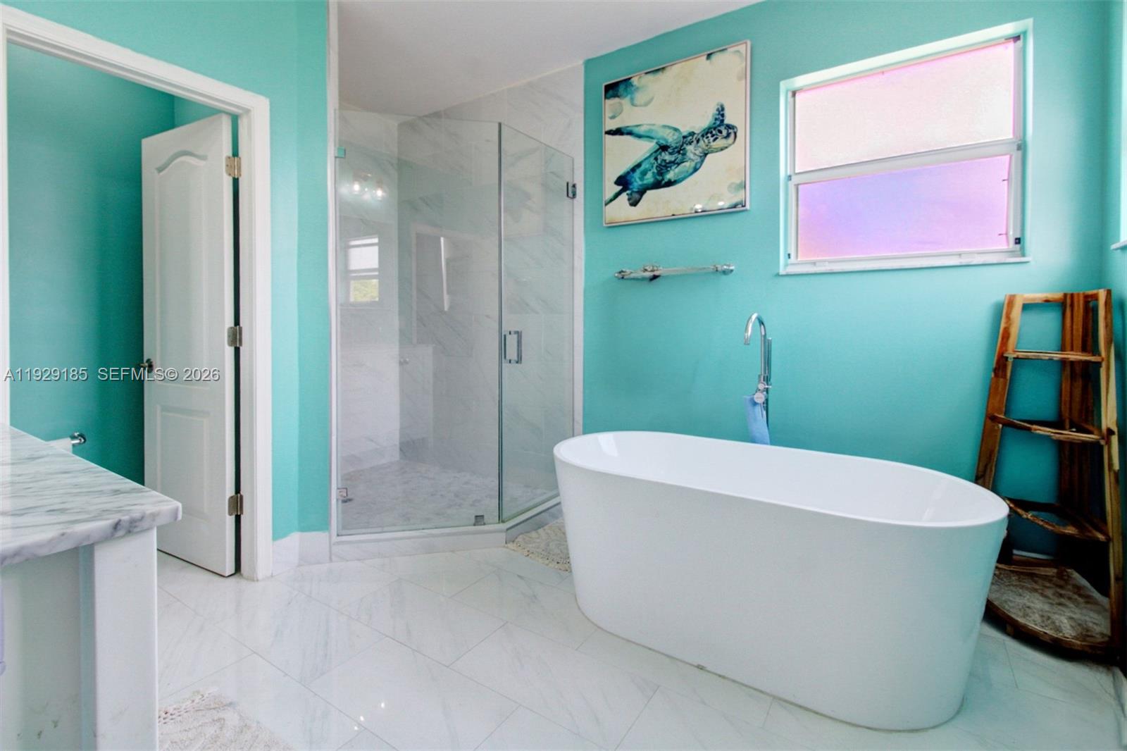 1156 Northeast 37th Place Homestead, FL 33033 - Photo 16 of 35 a white bath tub sitting in a bathroom