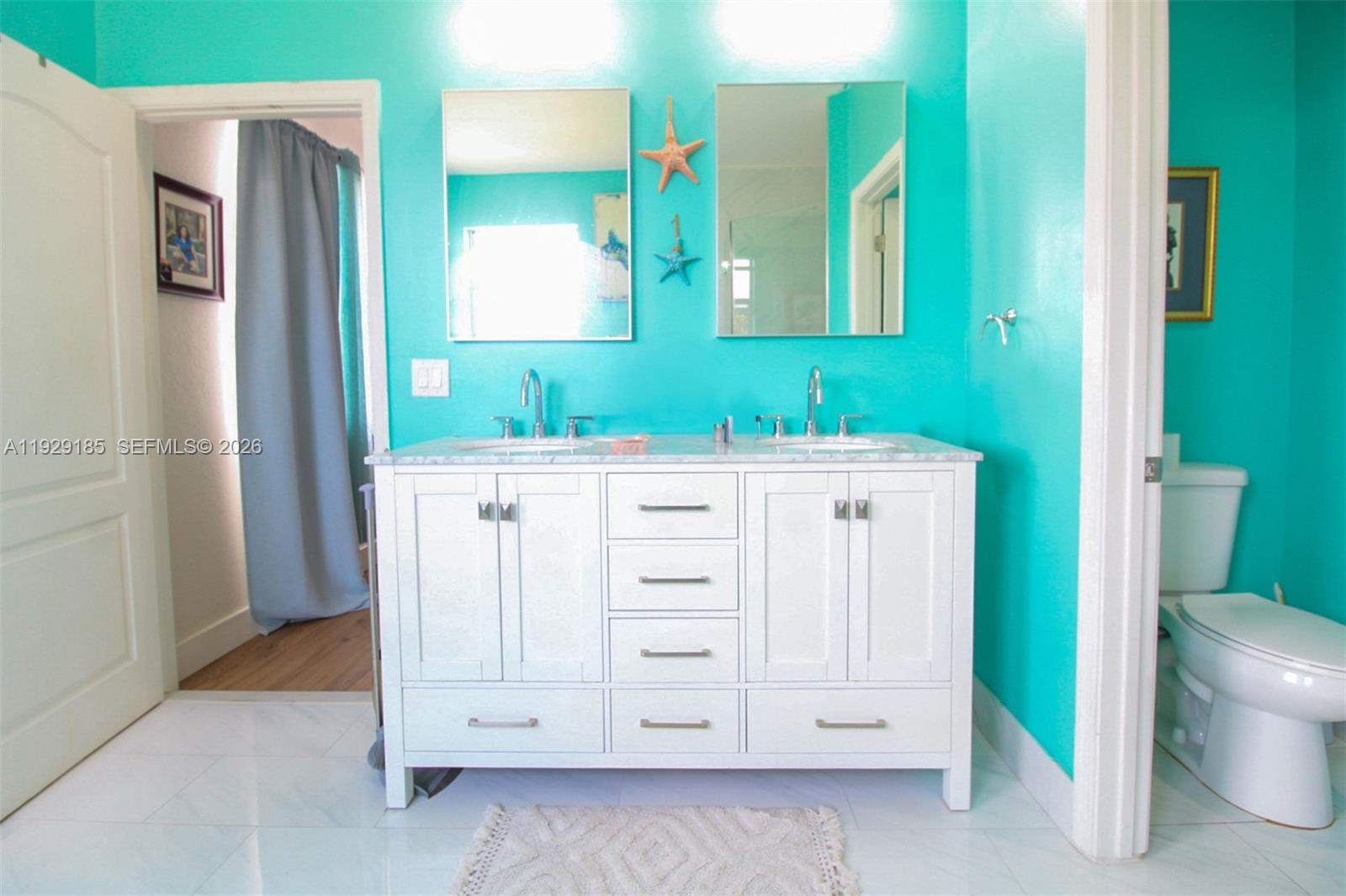 1156 Northeast 37th Place Homestead, FL 33033 - Photo 17 of 35 a bathroom with a double vanity sink and a mirror