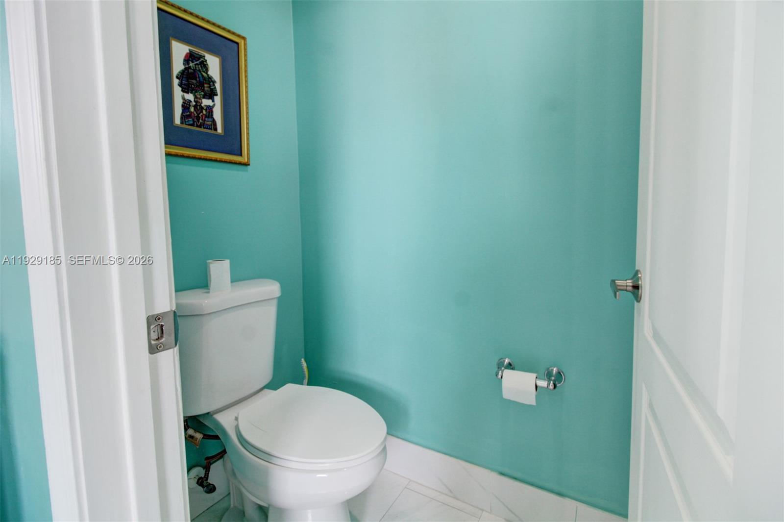 1156 Northeast 37th Place Homestead, FL 33033 - Photo 18 of 35 a white toilet sitting next to a small bathroom