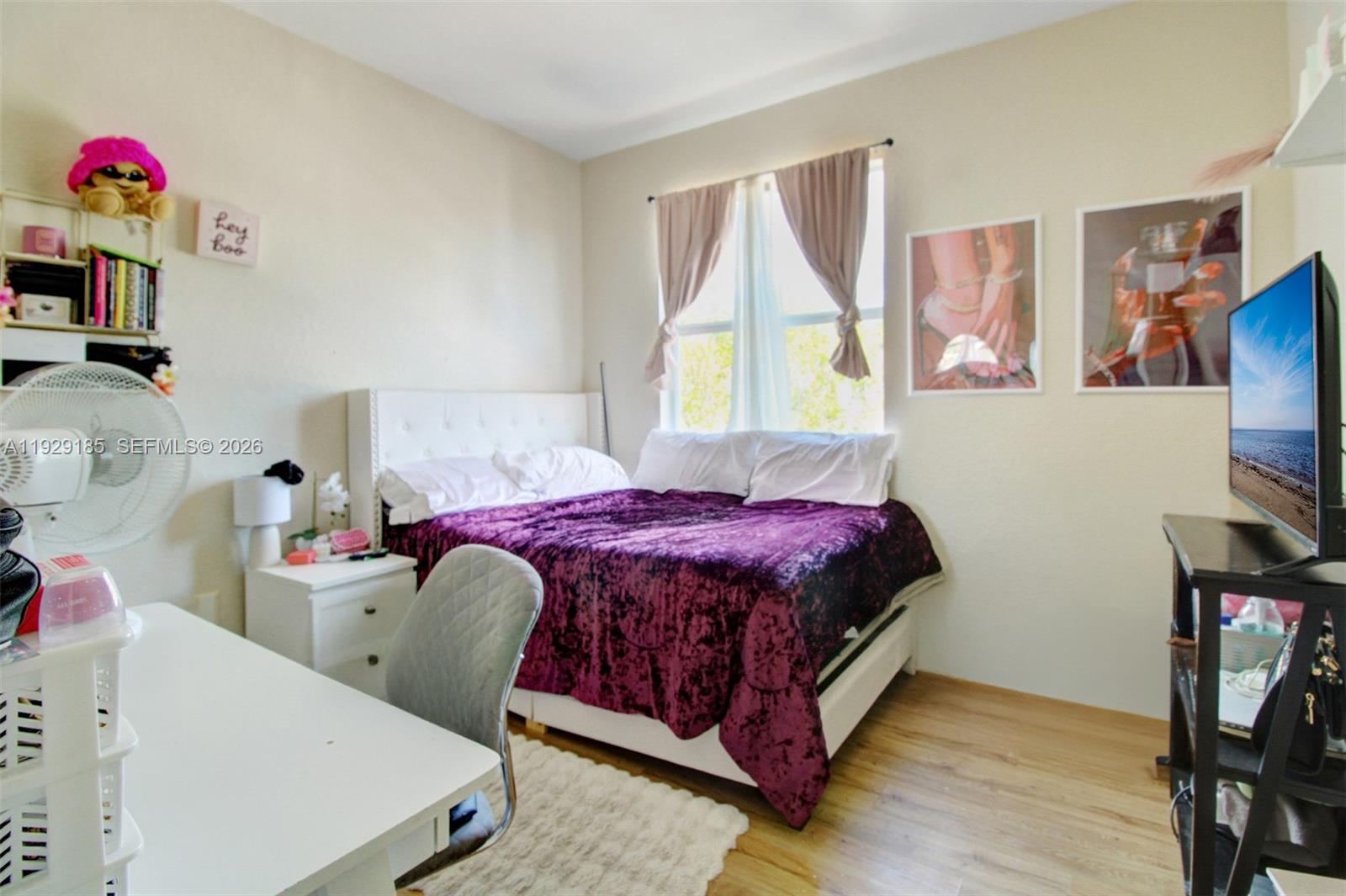 1156 Northeast 37th Place Homestead, FL 33033 - Photo 20 of 35 a bedroom with a bed and a table in it