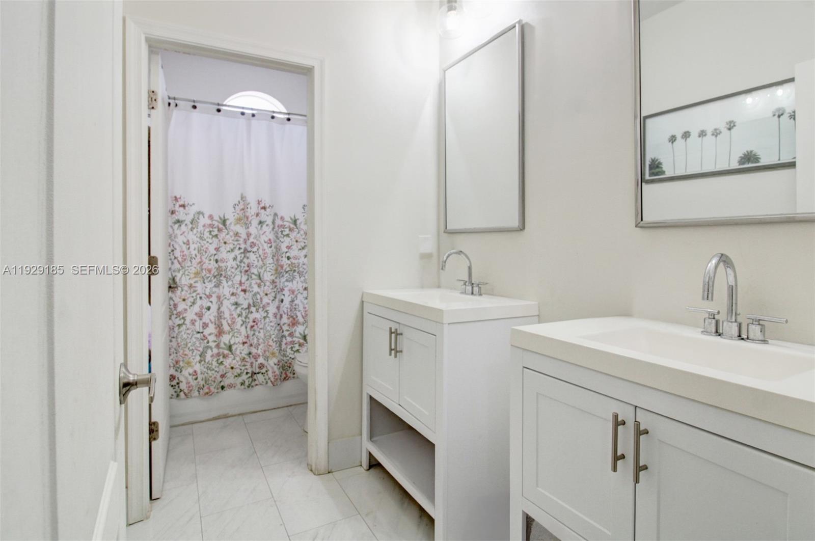 1156 Northeast 37th Place Homestead, FL 33033 - Photo 21 of 35 a bathroom with a sink and a mirror