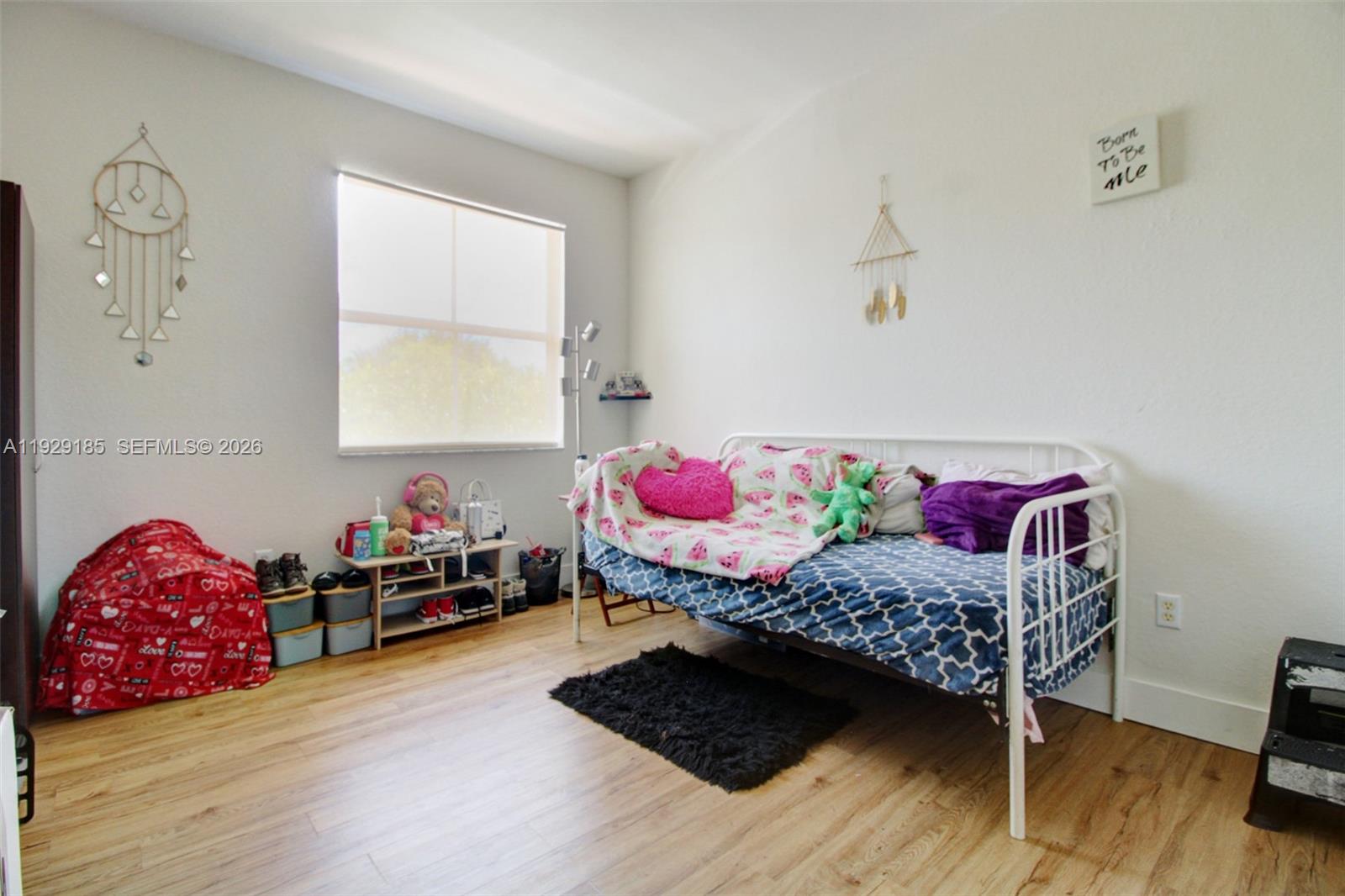 1156 Northeast 37th Place Homestead, FL 33033 - Photo 23 of 35 a bedroom with a bed and wooden floor