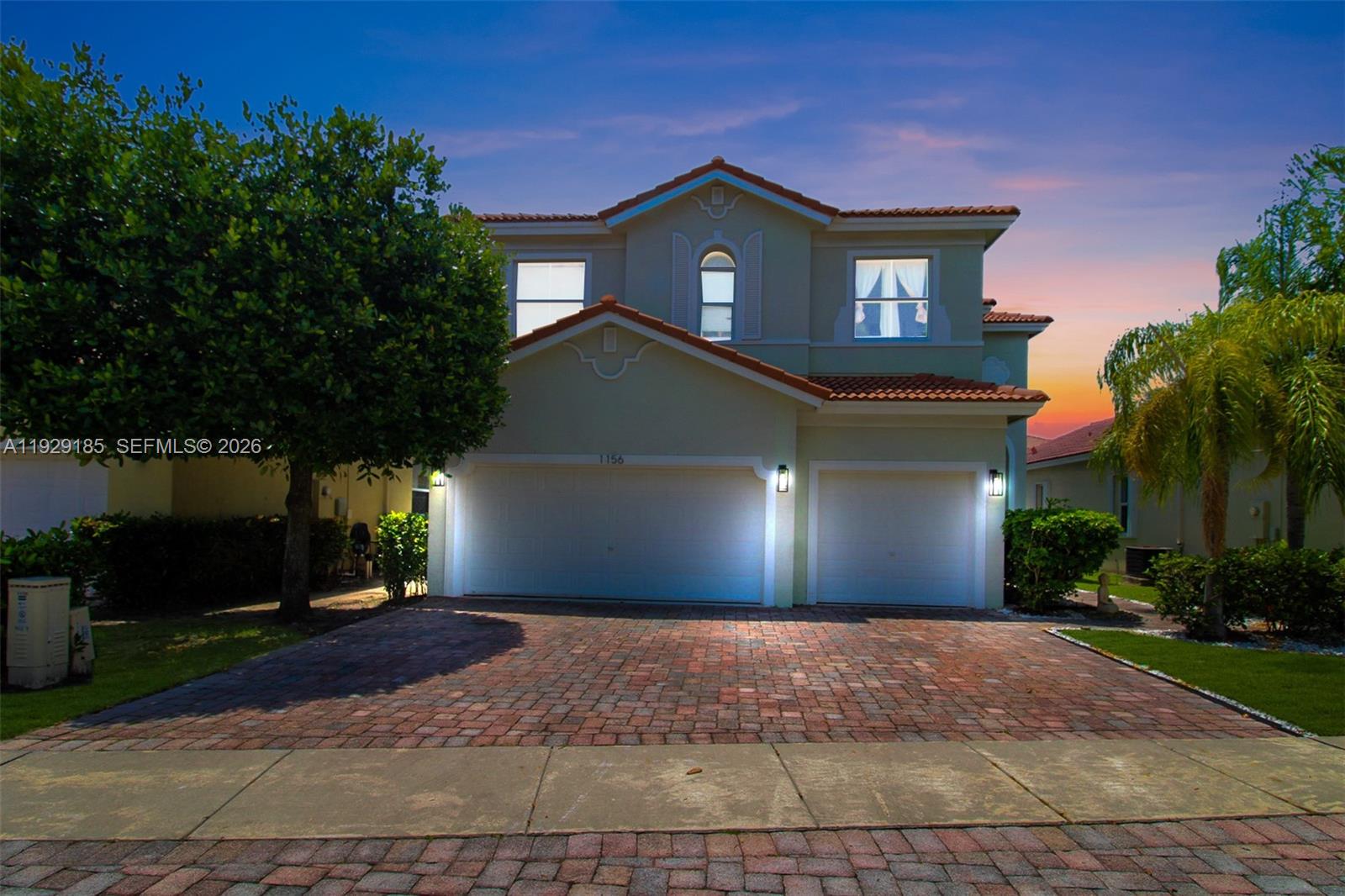1156 Northeast 37th Place Homestead, FL 33033 - Photo 29 of 35 a front view of a house with a yard and garage