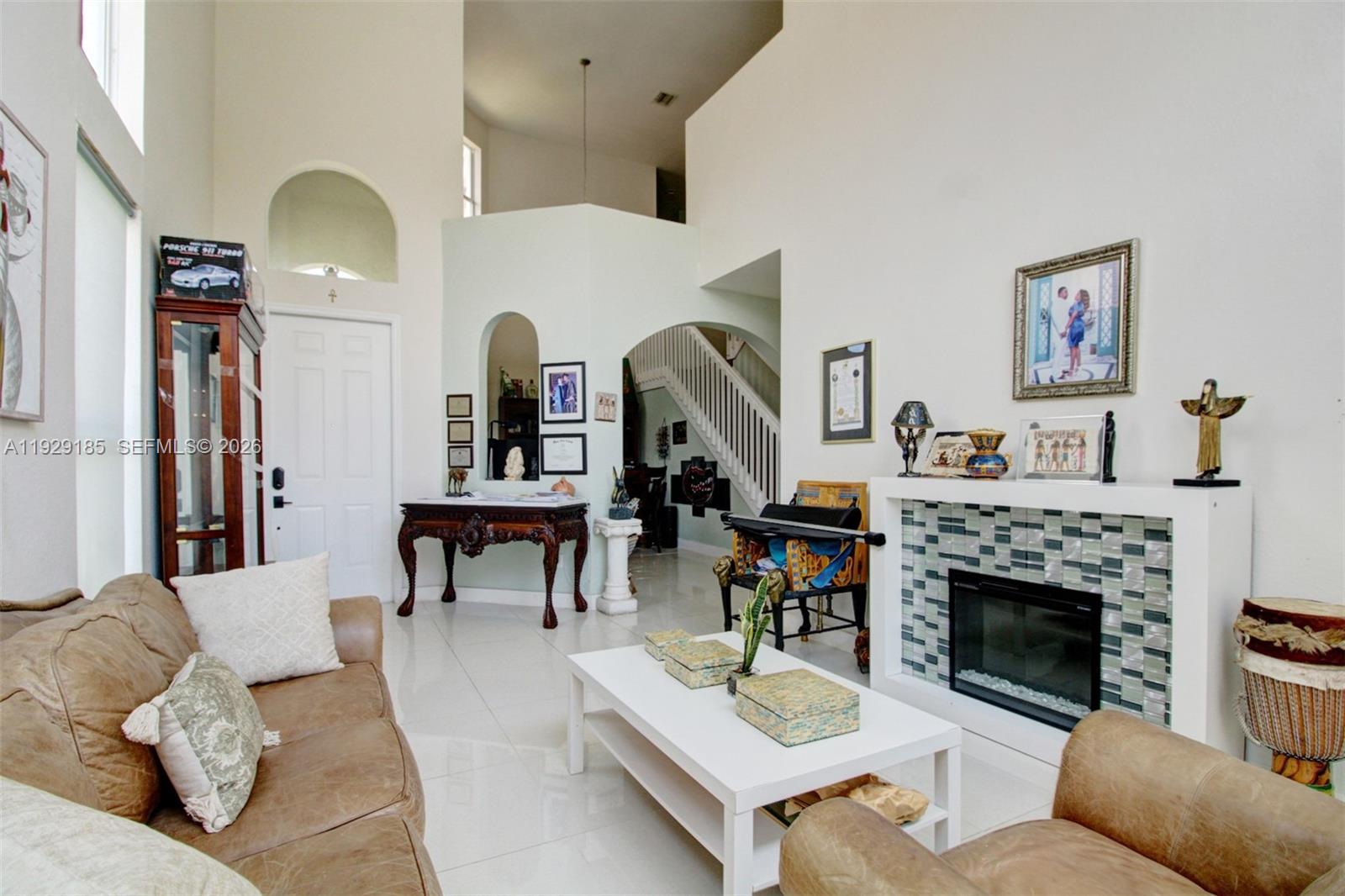 1156 Northeast 37th Place Homestead, FL 33033 - Photo 3 of 35 a living room with furniture and a fireplace