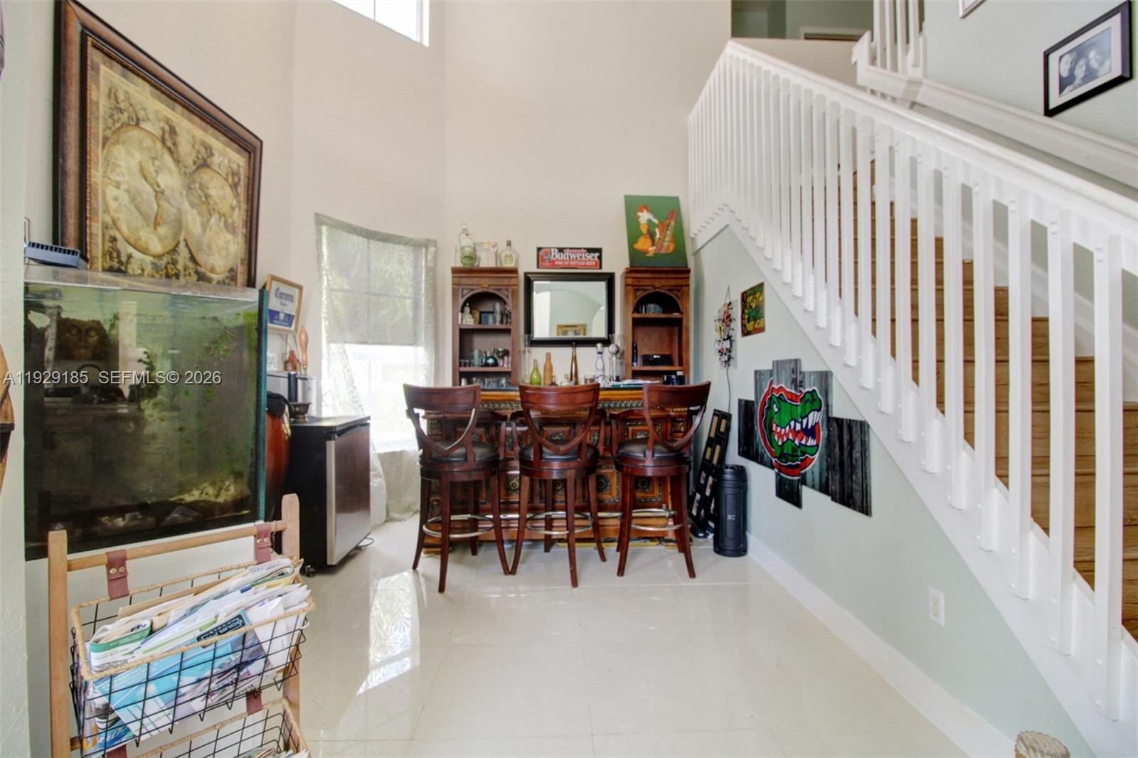 1156 Northeast 37th Place Homestead, FL 33033 - Photo 4 of 35 a dining room with furniture and a floor to ceiling window