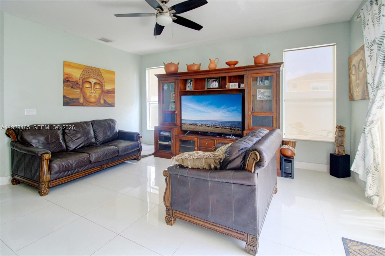 1156 Northeast 37th Place Homestead, FL 33033 - Photo 8 of 35 a living room with furniture and a flat screen tv