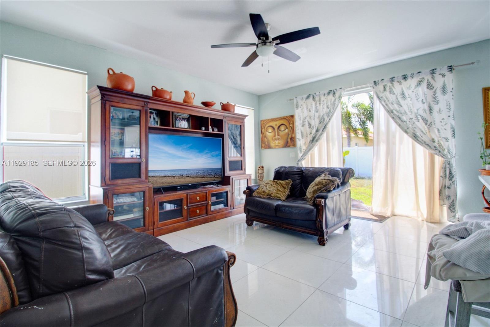 1156 Northeast 37th Place Homestead, FL 33033 - Photo 9 of 35 a living room with furniture and a flat screen tv