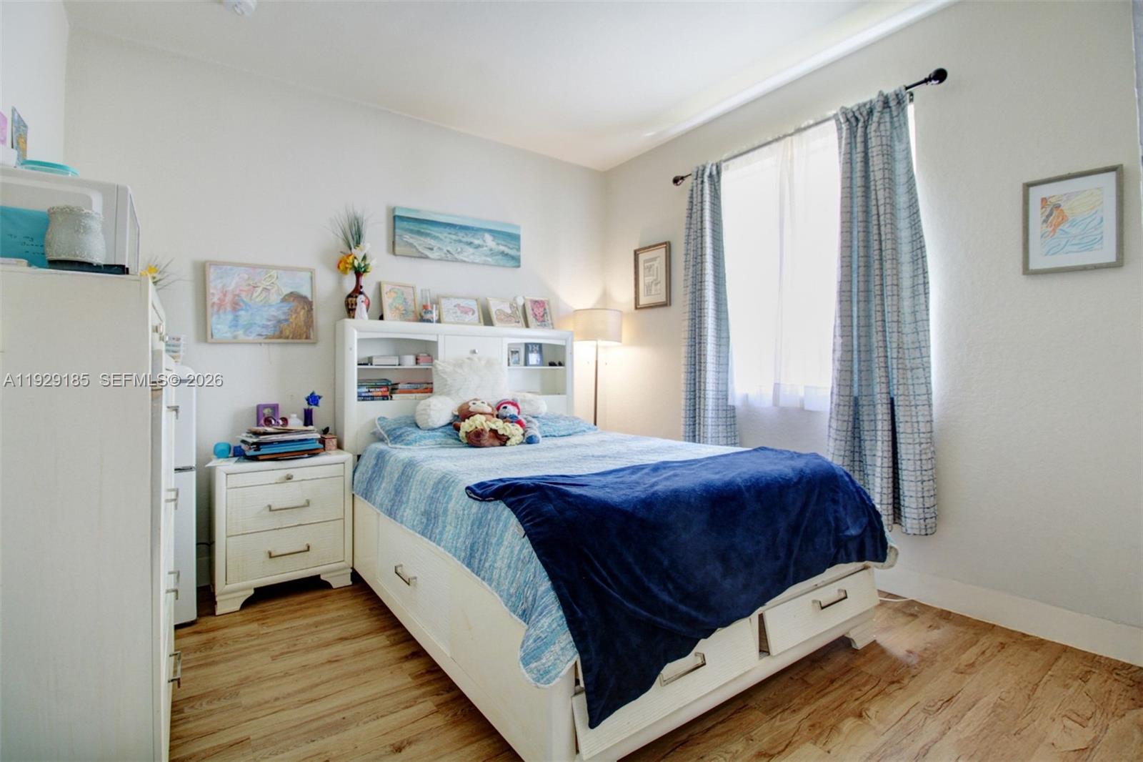 1156 Northeast 37th Place Homestead, FL 33033 - Photo 10 of 35 a bed room with a bed and a window
