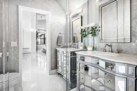 a bedroom with furniture and a large window