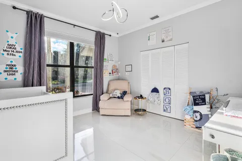 a living room with furniture and large windows