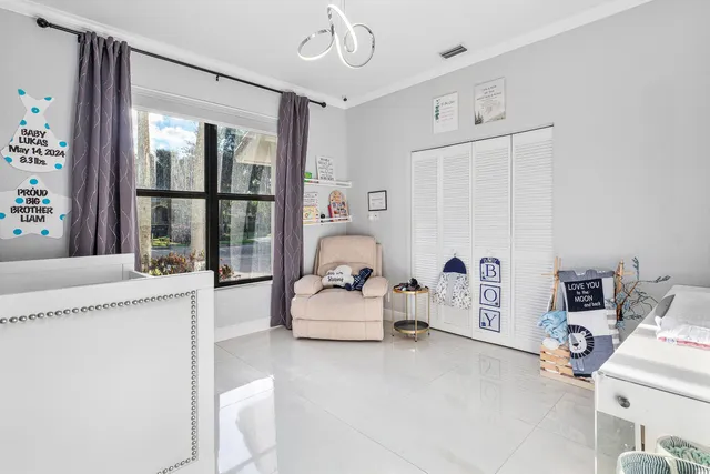 a living room with furniture and large windows