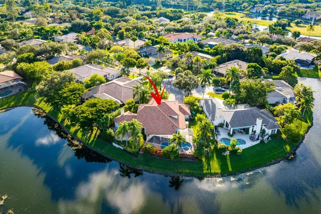 an aerial view of a house with a yard and swimming pool