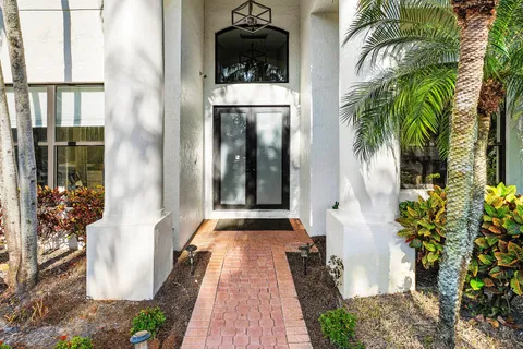 a front view of a house with a potted plant