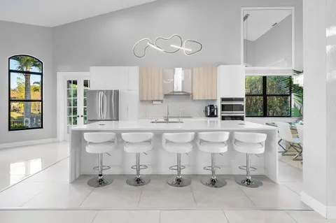 a kitchen with stainless steel appliances a sink and a refrigerator