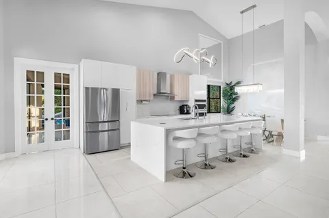 a dining room with furniture and view of kitchen