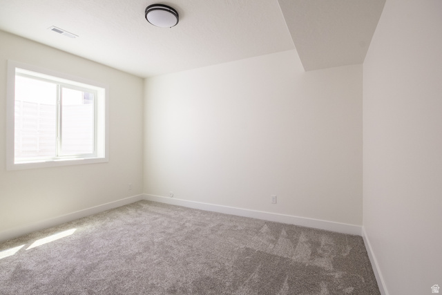 3322 250 S Street Vernal, UT 84078 - Photo 25 of 37 Carpeted interior space featuring a single window with white trim, a flush-mount ceiling light fixture, white walls, and white baseboards