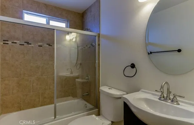 a bathroom with a shower a toilet and sink